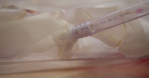 White medical syringe on table.