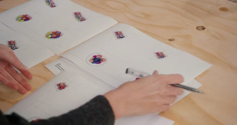 Hand over paper covered in stickers