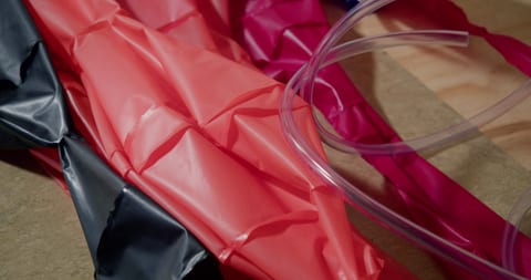 A roll of red wrapping paper on table.