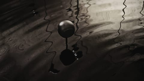 Chalk cellar with water surface disturbed by wave machine.