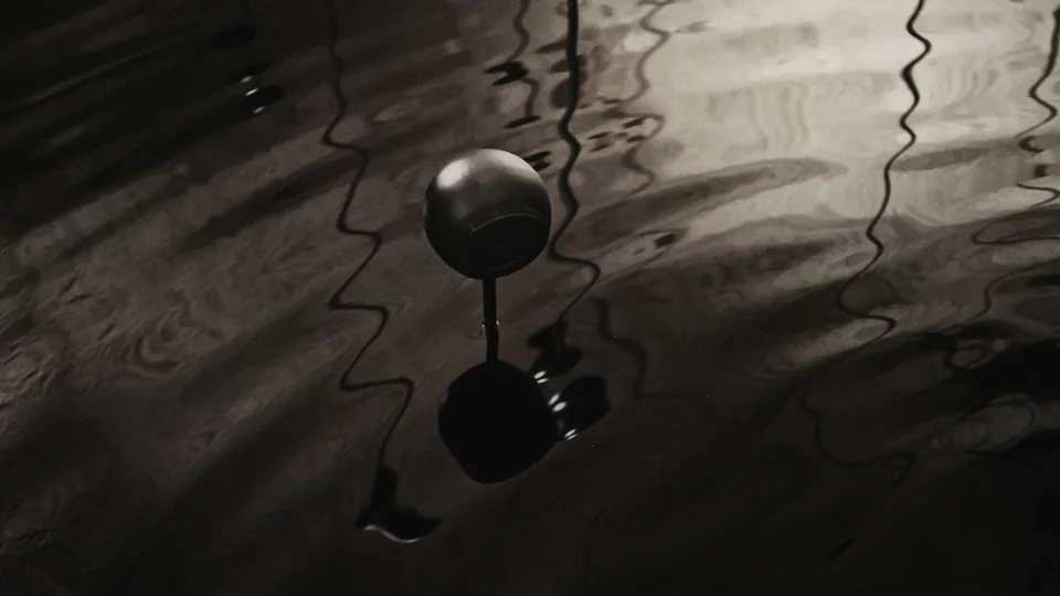 Chalk cellar with water surface disturbed by wave machine.