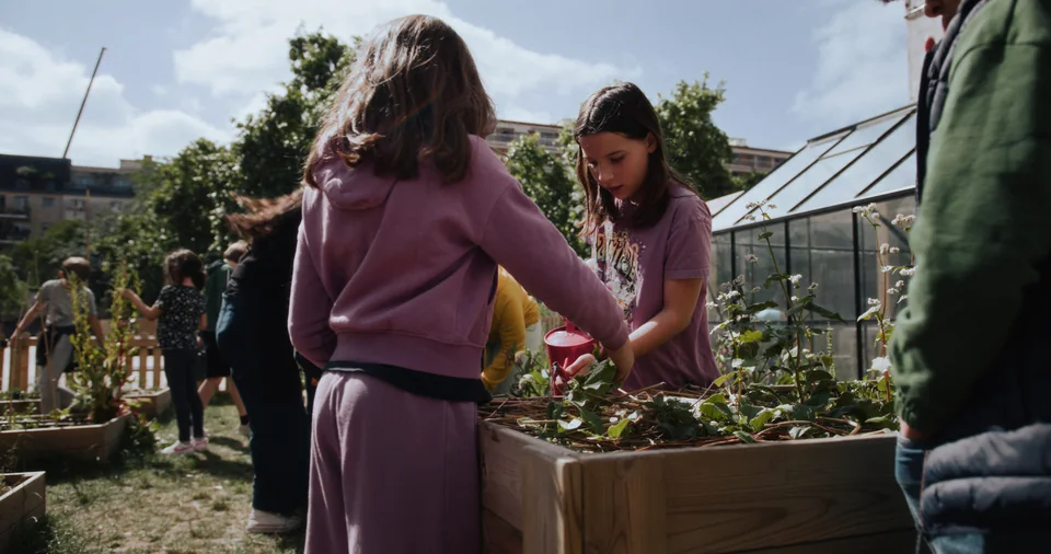 Children in a garden planting plants.