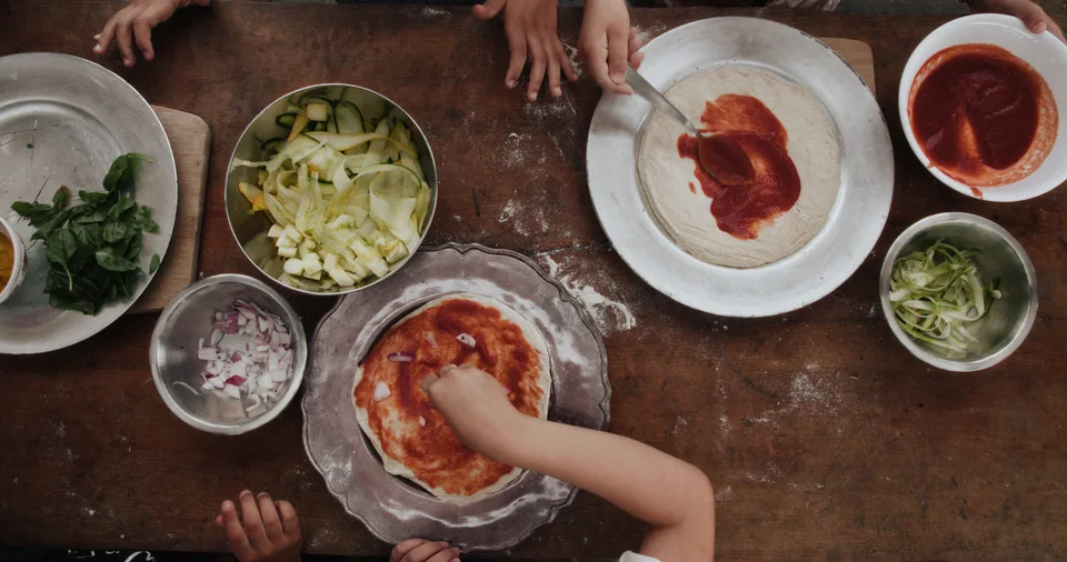 A collage of pizzas and people making pizza.