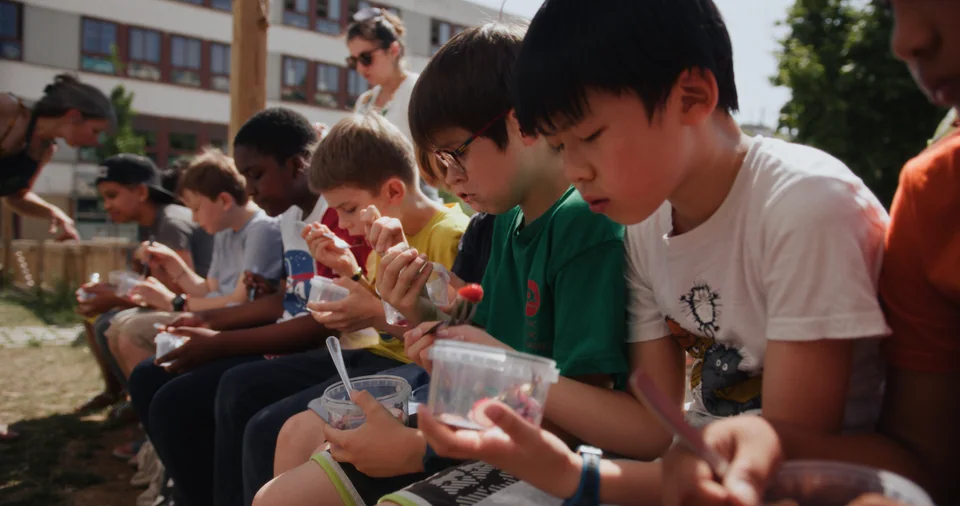 Kids eating ice cream at school.