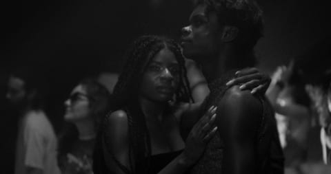 A young man and woman in a club.