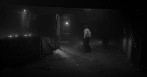 A young woman navigates a mysterious empty techno club, alone, trying to find a way out.